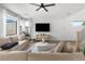 Comfortable living room featuring large windows, a ceiling fan, and a cozy sofa at 6142 W Levi Ave, Las Vegas, NV 89141