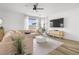 Inviting living room features a plush sectional, hardwood floors, and natural lighting at 6142 W Levi Ave, Las Vegas, NV 89141