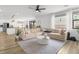 Open concept living room with a large sectional, hardwood floors and abundant natural light at 6142 W Levi Ave, Las Vegas, NV 89141