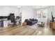 Comfortable living room featuring modern furniture, light wood floors, and bright windows at 6142 W Levi Ave, Las Vegas, NV 89141