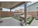 Undercover outdoor kitchen with modern appliances, dining area and artificial turf at 6142 W Levi Ave, Las Vegas, NV 89141