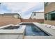 Luxury pool with tanning ledge and built-in spa, seamlessly blending with the backyard's modern design at 6142 W Levi Ave, Las Vegas, NV 89141