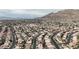 Broad aerial capture reveals a community with organized streets, tidy homes, and majestic mountain views at 6407 Wild Strawberry Ln, Las Vegas, NV 89142