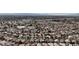 Vast aerial perspective showcases an orderly neighborhood layout with rows of homes and a prominent school building at 6407 Wild Strawberry Ln, Las Vegas, NV 89142