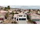 View of home in suburban neighborhood with desert landscaping and red-tile roofs at 6407 Wild Strawberry Ln, Las Vegas, NV 89142