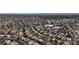 Expansive aerial view of a residential neighborhood with neatly arranged houses, streets, and distant city skyline at 6407 Wild Strawberry Ln, Las Vegas, NV 89142