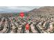 Scenic aerial neighborhood view showcasing E. Charleston Blvd, nearby houses, and impressive mountain landscapes at 6407 Wild Strawberry Ln, Las Vegas, NV 89142