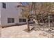 Exterior shot of backyard with hardscape and views of a two story home at 6407 Wild Strawberry Ln, Las Vegas, NV 89142