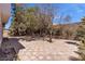 Spacious backyard features trees and hardscape, perfect for outdoor living and entertaining at 6407 Wild Strawberry Ln, Las Vegas, NV 89142