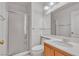 Bright bathroom boasts a glass door shower, oak cabinet and large mirror at 6407 Wild Strawberry Ln, Las Vegas, NV 89142