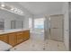 Bright bathroom features a double vanity, large mirror, soaking tub, and glass-enclosed shower at 6407 Wild Strawberry Ln, Las Vegas, NV 89142