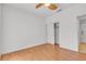 Bedroom with wood floors and ceiling fan has a closet for storage at 6407 Wild Strawberry Ln, Las Vegas, NV 89142