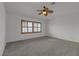 Bedroom with ceiling fan features carpeted floors and window with wooden blinds at 6407 Wild Strawberry Ln, Las Vegas, NV 89142