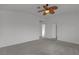 Bedroom with ceiling fan has carpeted floors and ensuite bathroom with oak cabinet at 6407 Wild Strawberry Ln, Las Vegas, NV 89142