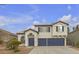 Charming two-story home with a desert landscape, two car garage, and decorative blue trim at 6407 Wild Strawberry Ln, Las Vegas, NV 89142