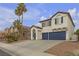 Inviting two-story home with palm trees, desert landscape and a two-car garage at 6407 Wild Strawberry Ln, Las Vegas, NV 89142
