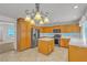 Well-lit kitchen featuring wood cabinets, stainless steel appliances and tile flooring at 6407 Wild Strawberry Ln, Las Vegas, NV 89142