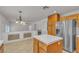 Eat-in kitchen featuring island, stainless steel appliances, and tiled flooring at 6407 Wild Strawberry Ln, Las Vegas, NV 89142