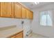 Laundry room features ample cabinet storage space and tile flooring at 6407 Wild Strawberry Ln, Las Vegas, NV 89142
