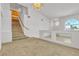 Spacious living room featuring staircase and decorative railing with mirrors at 6407 Wild Strawberry Ln, Las Vegas, NV 89142