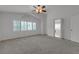 Spacious main bedroom featuring neutral carpet, lots of windows, and a ceiling fan at 6407 Wild Strawberry Ln, Las Vegas, NV 89142