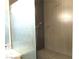 Walk-in shower with a built-in seat and gray tiling at 6480 Annie Oakley Dr # 111, Las Vegas, NV 89120