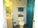 Inviting bathroom featuring a decorated toilet, vanity with storage, and a stylish blue shower curtain at 6480 Annie Oakley Dr # 111, Las Vegas, NV 89120