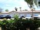 Exterior view of the building featuring multiple parking spaces and well-maintained landscaping at 6480 Annie Oakley Dr # 111, Las Vegas, NV 89120