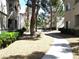 Exterior of a home with lush landscaping and a paved walkway at 6480 Annie Oakley Dr # 111, Las Vegas, NV 89120