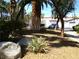 Serene front yard featuring rock landscaping and mature trees at 6480 Annie Oakley Dr # 111, Las Vegas, NV 89120