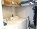 Functional laundry room with washer, dryer, and shelving for organized storage at 6480 Annie Oakley Dr # 111, Las Vegas, NV 89120