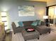 Cozy living room featuring a comfortable sectional sofa, ottoman, and stylish decor at 6480 Annie Oakley Dr # 111, Las Vegas, NV 89120