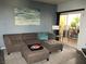 Comfortable living room with a plush sectional, stylish decor, and access to a relaxing outdoor balcony at 6480 Annie Oakley Dr # 111, Las Vegas, NV 89120