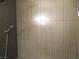 Contemporary shower with sleek, vertically-tiled walls and a modern showerhead for a spa-like feel at 6480 Annie Oakley Dr # 111, Las Vegas, NV 89120