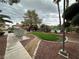 A common area features a lawn, tropical trees, and walkways, with a glimpse of the community pool at 6749 Charleston Blvd # 3, Las Vegas, NV 89146