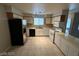 Well-lit kitchen featuring white cabinets, tile flooring, and stainless steel appliances at 6749 Charleston Blvd # 3, Las Vegas, NV 89146