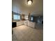 The kitchen features white cabinetry, a stainless steel refrigerator, and tiled floors for a modern look at 6749 W Charleston Blvd # 2, Las Vegas, NV 89146
