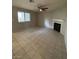 A spacious living room features tile flooring, a ceiling fan, and a fireplace, creating a cozy atmosphere at 6749 W Charleston Blvd # 2, Las Vegas, NV 89146