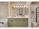 Bathroom with double sinks, cabinet storage, and open access to a shower stall at 708 Canterbury Cross Pl, Las Vegas, NV 89144