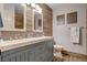 Modern bathroom with double sinks, wood-look tile and a decorative wall design at 708 Canterbury Cross Pl, Las Vegas, NV 89144