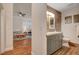 Stylish half-bathroom with a modern vanity and tile flooring adjacent to the living room at 708 Canterbury Cross Pl, Las Vegas, NV 89144