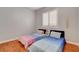 Bedroom with two twin beds, neutral walls, plantation shutters and hardwood floors at 708 Canterbury Cross Pl, Las Vegas, NV 89144