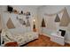 A bedroom featuring a woodland theme, hardwood floors and natural light at 708 Canterbury Cross Pl, Las Vegas, NV 89144