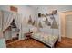 A bedroom featuring a woodland theme, hardwood floors and natural light at 708 Canterbury Cross Pl, Las Vegas, NV 89144