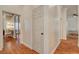 Bright hallway with wood floors and neutral paint, leading to bedrooms and living spaces at 708 Canterbury Cross Pl, Las Vegas, NV 89144