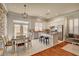 Open kitchen and dining area with stainless steel appliances, granite countertops, and an island with seating at 708 Canterbury Cross Pl, Las Vegas, NV 89144