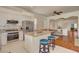 Bright kitchen with stainless steel appliances, granite countertops, an island, and hardwood floors at 708 Canterbury Cross Pl, Las Vegas, NV 89144
