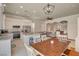 Eat-in kitchen featuring granite countertops, stainless steel appliances, and breakfast bar seating at 708 Canterbury Cross Pl, Las Vegas, NV 89144