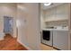 Convenient laundry area featuring modern appliances and easy access from the hallway at 708 Canterbury Cross Pl, Las Vegas, NV 89144