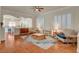 Open-concept living room featuring hardwood floors, plantation shutters, and stylish furnishings at 708 Canterbury Cross Pl, Las Vegas, NV 89144